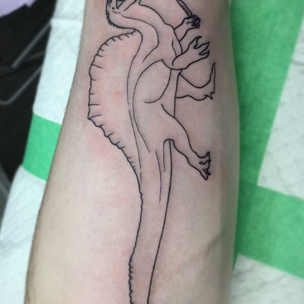 atticus tattoo, line tattoo of a dinosaur holding a knife