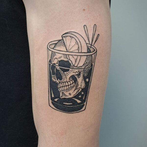 atticus tattoo, black and grey tattoo of a shot glass with a skull head and lemon wedge in it