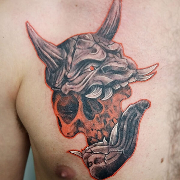 attiucs tattoo, black and grey oni mask with an exposed, red skull underneath