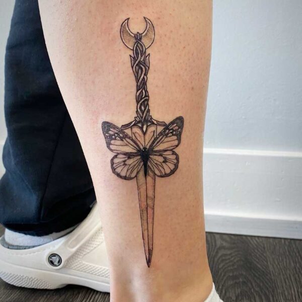 atticus tattoo, black and grey tattoo of a butterfly with a dagger