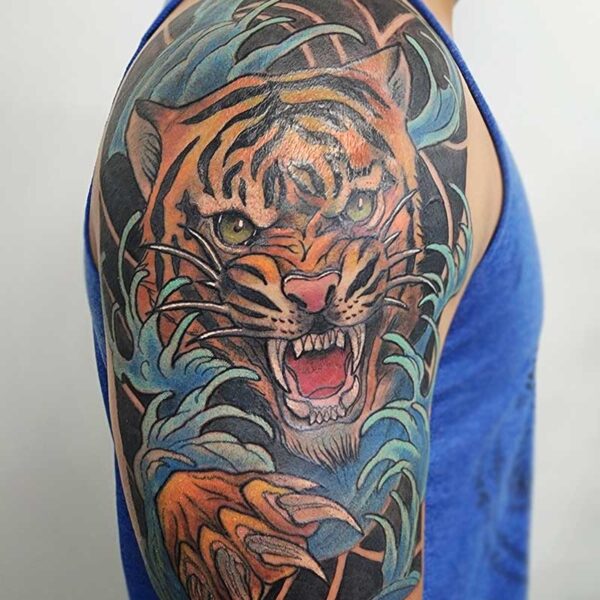 atticus tattoo, neotraditional tattoo of a tiger with blue waves around it
