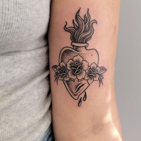 atticus tattoo, black and grey American traditional tattoo of a flaming heart with roses