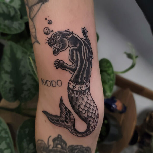 atticus tattoo, black and grey American traditional tattoo of a black panther with a mermaid tail