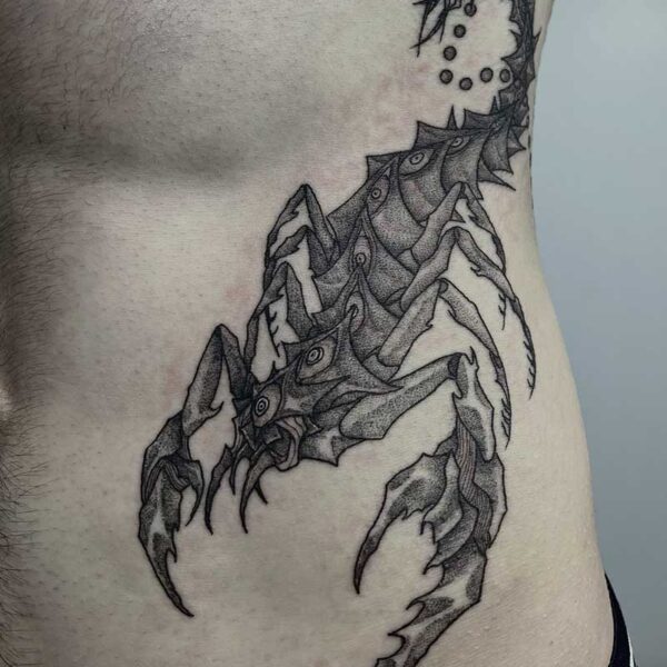 atticus tattoo; black and grey tattoo of a monster scorpion