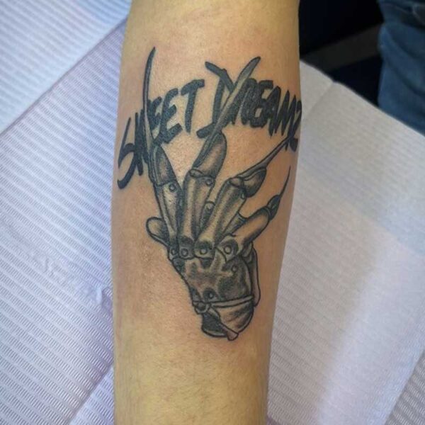 atticus tattoo, black and grey tattoo of Freddy Krueger's glove