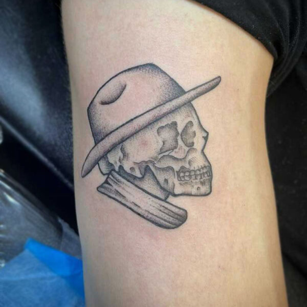 atticus tattoo, black and grey tattoo of a skull wearing a cowboy hat and scarf