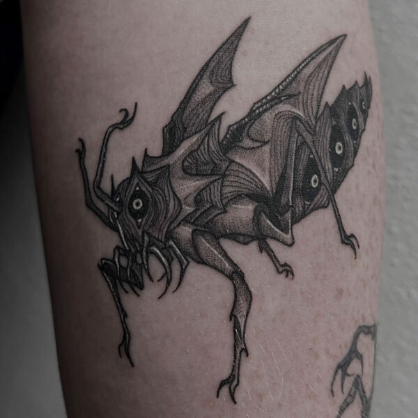 atticus tattoo, black and grey tattoo of a monster grasshopper