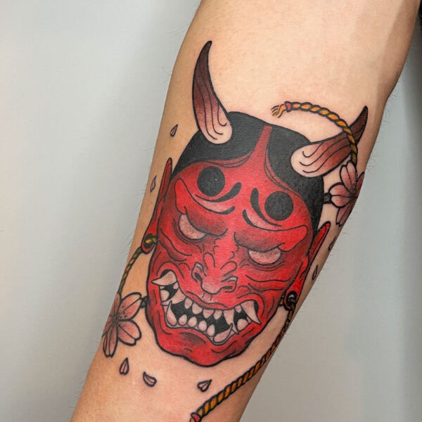 atticus tattoo, red and black tattoo of an Oni mask