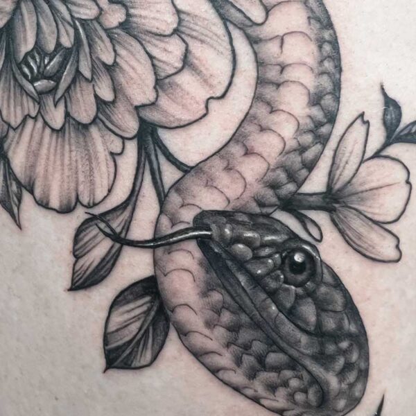 atticus tattoo, black and grey realism tattoo of a snake with flowers