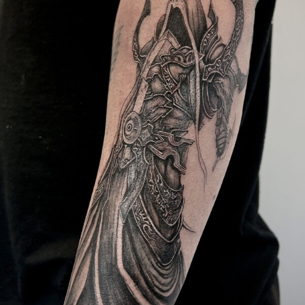 atticus tattoo, black and grey realism tattoo of a fantasy assassin in armour and a hood