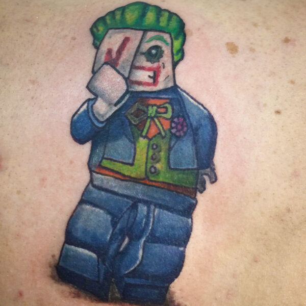 atticus tattoo, coloured tattoo of the Joker from Lego Batman