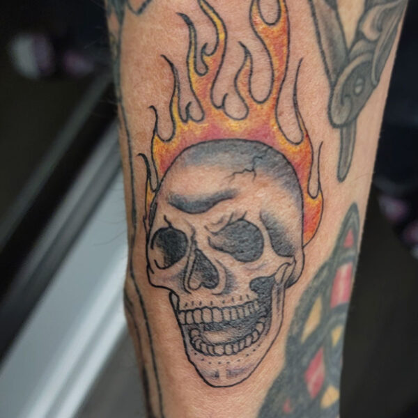 atticus tattoo, old school tattoo of a flaming skull head