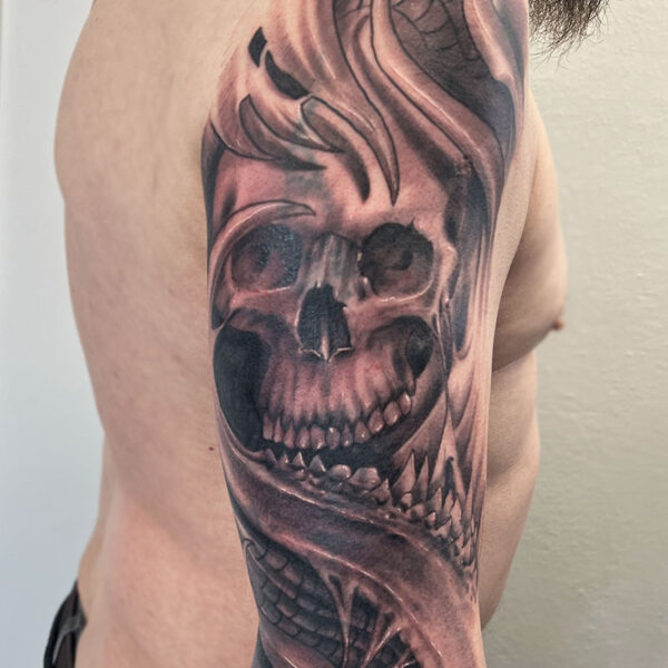 atticus tattoo, black and grey realism tattoo of a skull with torn cloth