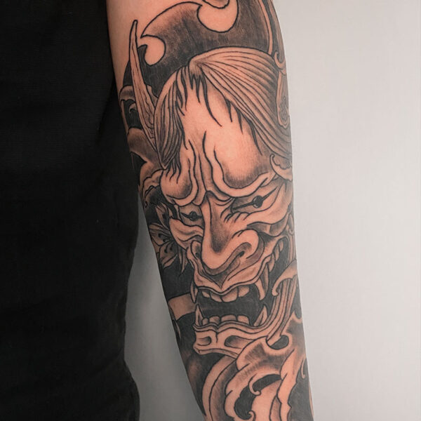 atticus tattoo, black and grey tattoo of a Japanese Oni Mask