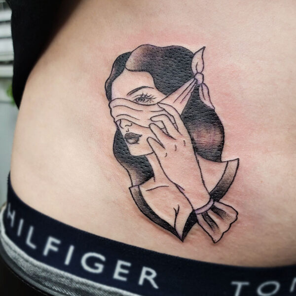 atticus tattoo, black and grey tattoo of a holding peeking from a blindfold
