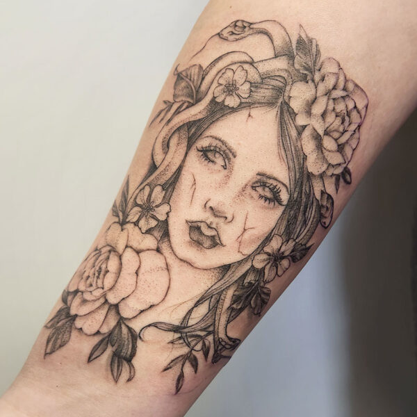 atticus tattoo, black and grey tattoo of Medusa with flowers in her hair