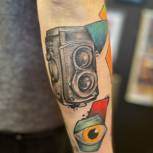 atticus tattoo, abstract tattoo of a speaker, eyeball and coloured geometric shapes