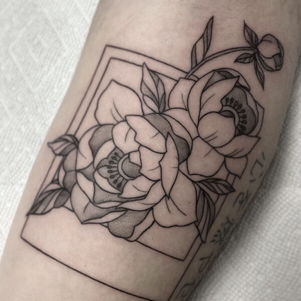 atticus tattoo, black and grey tattoo of peonies coming out of a polaroid photo