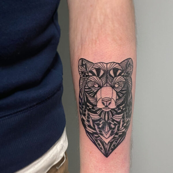 atticus tattoo, black and grey tattoo of a bears head made out of geometric shapes