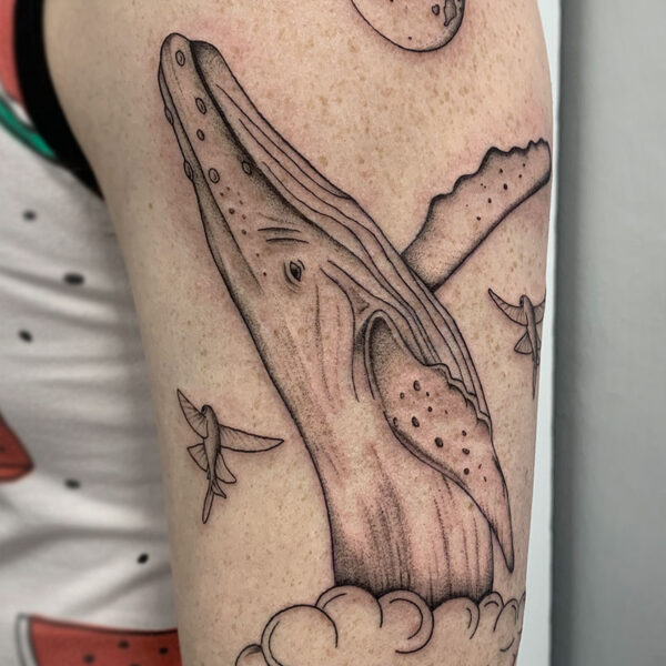 atticus tattoo, black and grey tattoo of a humpback whale jumping out of a cloud with the moon in the background