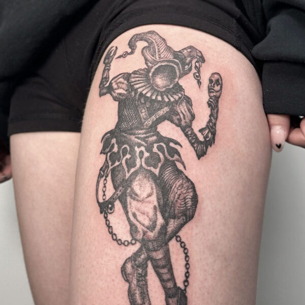atticus tattoo, black and grey, realism tattoo of a jester