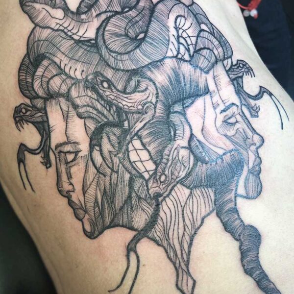 atticus tattoo, black and grey tattoo of a stylized, two faced Medusa