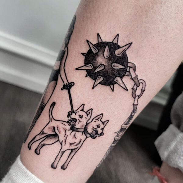 atticus tattoo, black and grey tattoo of a two headed dog and a spiked ball on a chain