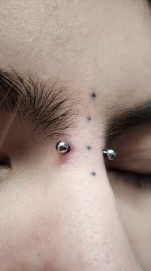 atticus tattoo, bridge piercing
