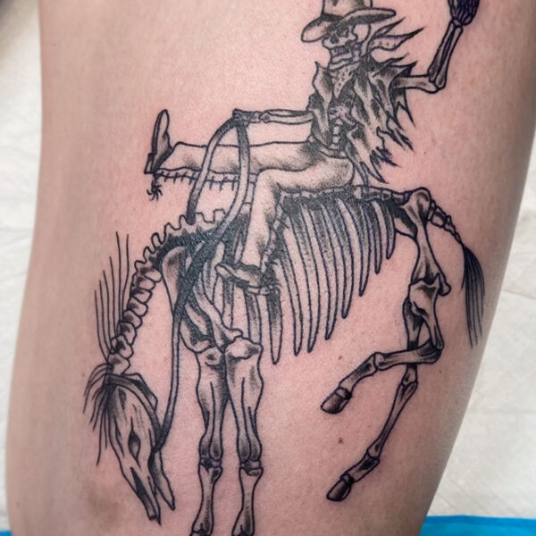 atticus tattoo, black and grey tattoo of a skeleton cowboy riding a bucking, skeleton horse