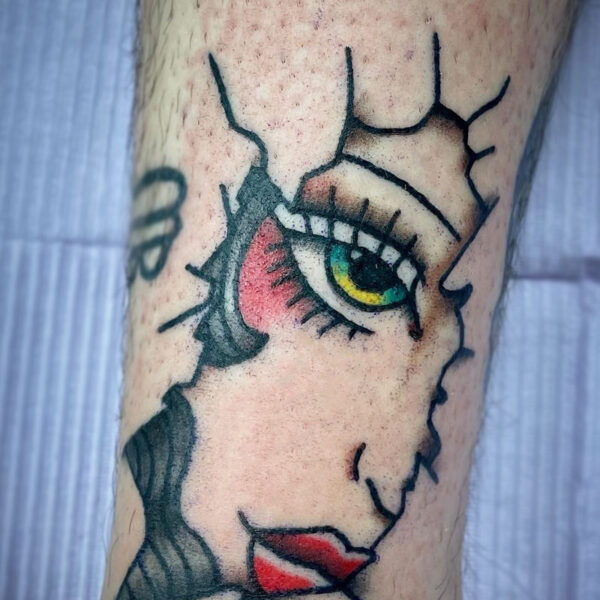 atticus tattoo, American Traditional tattoo of a woman's face peaking through a cracked hole