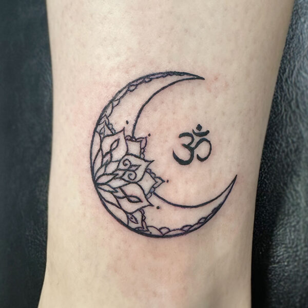 atticus tattoo, tattoo of a crescent moon with a mandala flower in it