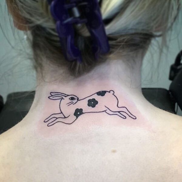 atticus tattoo, line tattoo of a rabbit with three black flowers