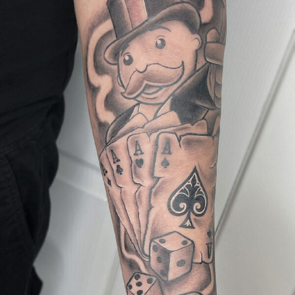 atticus tattoo, black and grey tattoo of the Monopoly Man with four aces and die