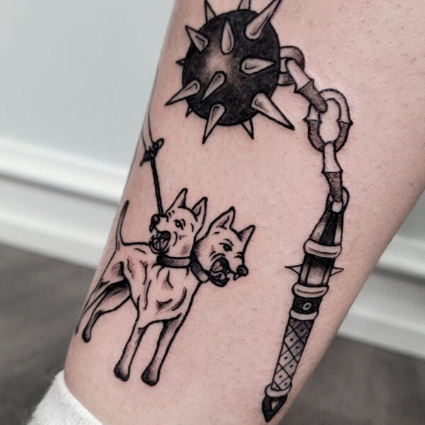 atticus tattoo, black and grey tattoo of a two headed dog and a spiked ball on a chain and decorated handle