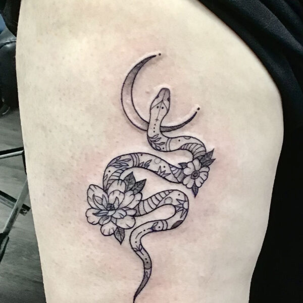 atticus tattoo, black and grey tattoo of a patterned snake with flowers and a crescent moon