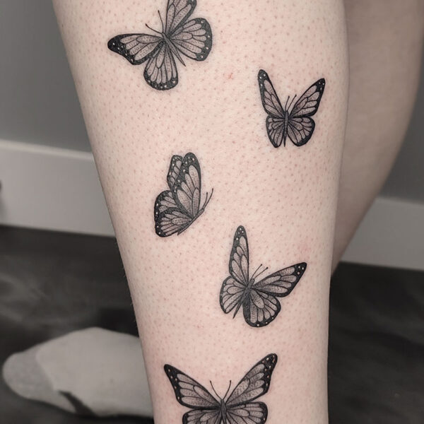 atticus tattoo, black and grey tattoos of several butterflies