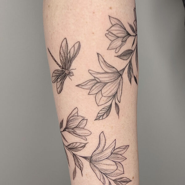 atticus tattoo, fine line tattoo of flowers and a dragonfly