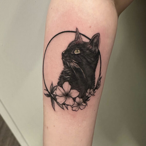 atticus tattoo, black and grey realism tattoo of a black cat with a circle and flowers