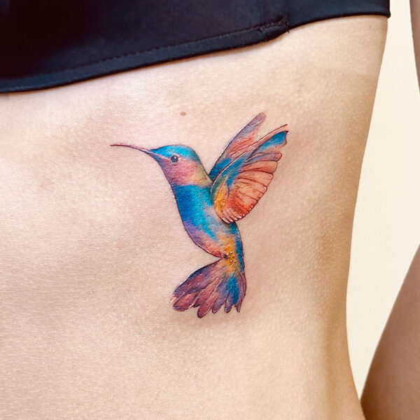 atticus tattoo, coloured tattoo of a hummingbird