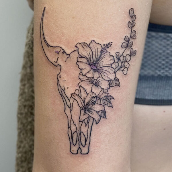 atticus tattoo, fine line tattoo of a cow skull with flowers