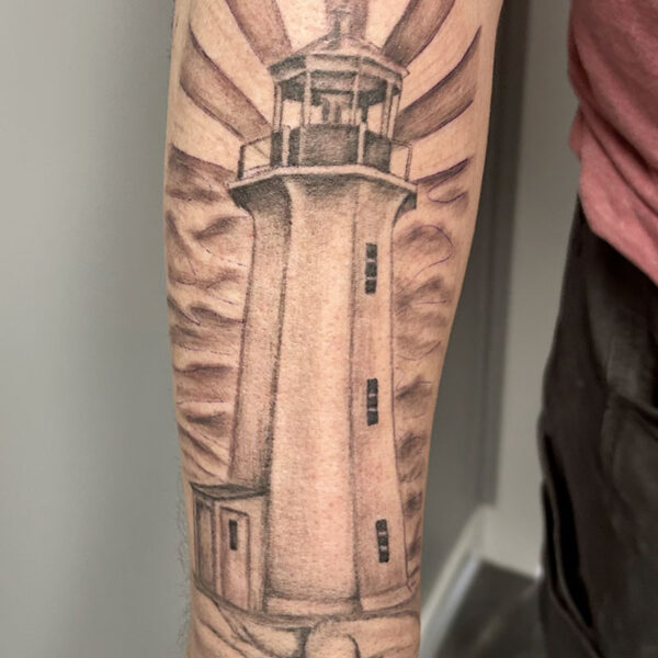 atticus tattoo, black and grey realism tattoo of a lighthouse scene