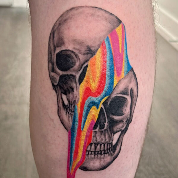 atticus tattoo, surrealism tattoo of a black and grey skull, split in half with rainbow liquid coming out of it