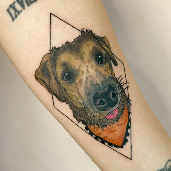 Pet portrait tattoo of a dog wearing an orange bandana