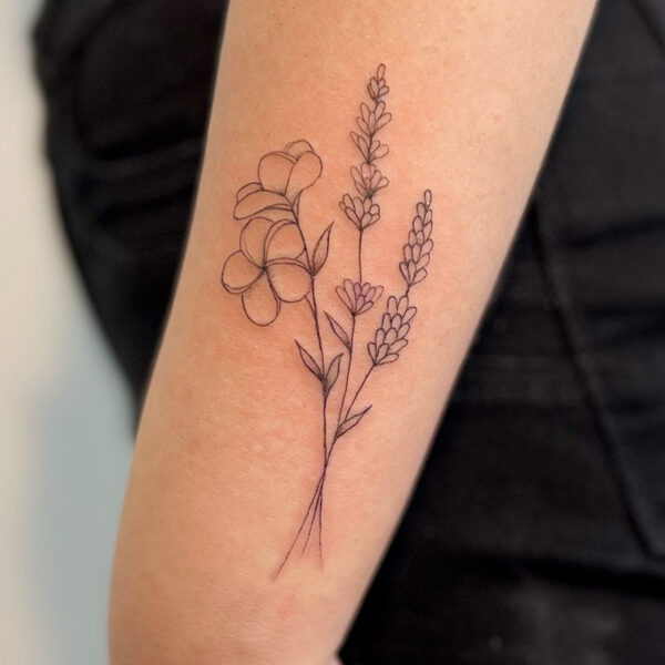Fine line tattoo of three stems of flowers