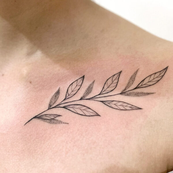 Fine line tattoo of a stem of leaves