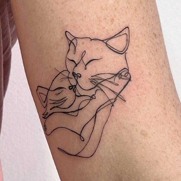 Line tattoo of two cats cuddling