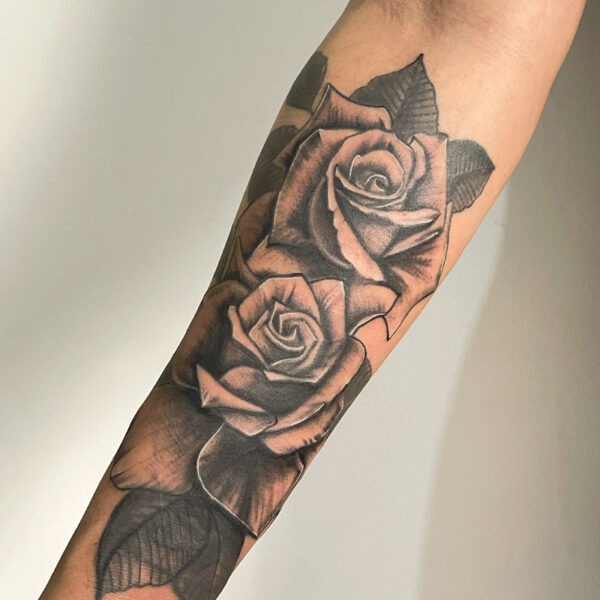 Realism tattoo of two black and grey roses