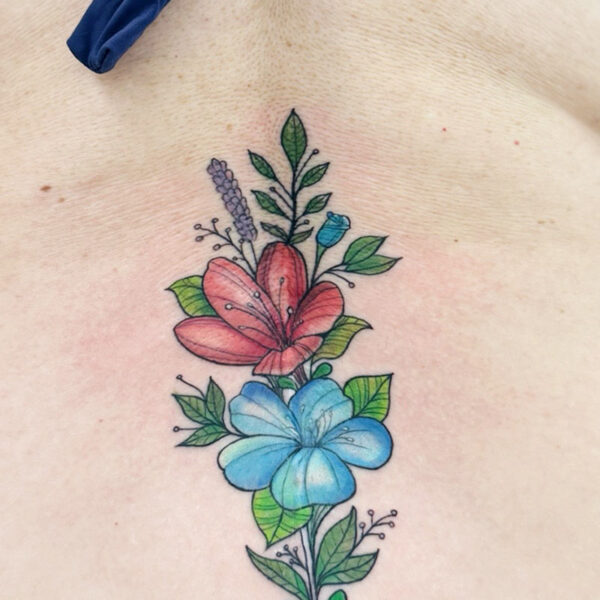 Tattoo of red and blue flowers with foliage