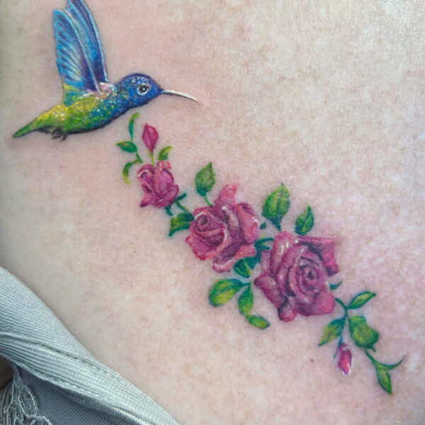 Atticus Tattoo| Colour, realism tattoo of a hummingbird and roses