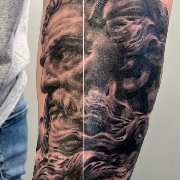 Atticus Tattoo| Black and grey, realism tattoo of a statue of a bearded man| God| Zeus